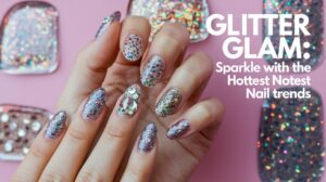 A photo of a hand with nails covered in glitter and glam. The nails have a variety of shapes and sizes, with some having small glitter particles and others having larger glitter particles. There are also some nails with sparkles and rhinestones. The background is a pink wall with the text "Glitter Glam: Sparkle with the Hottest Nail Trends".