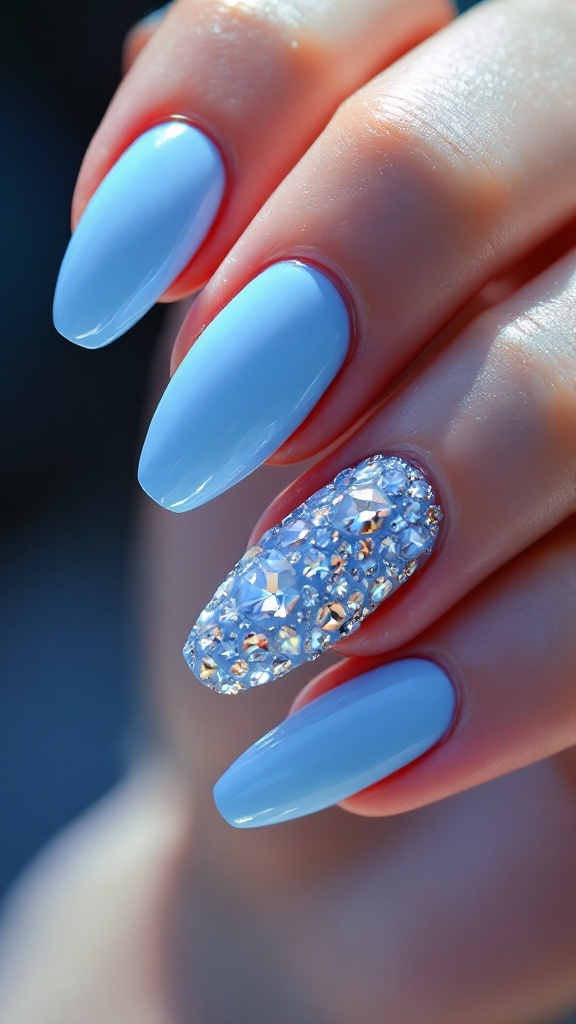 Glossy powder blue nails with one nail featuring rhinestones.